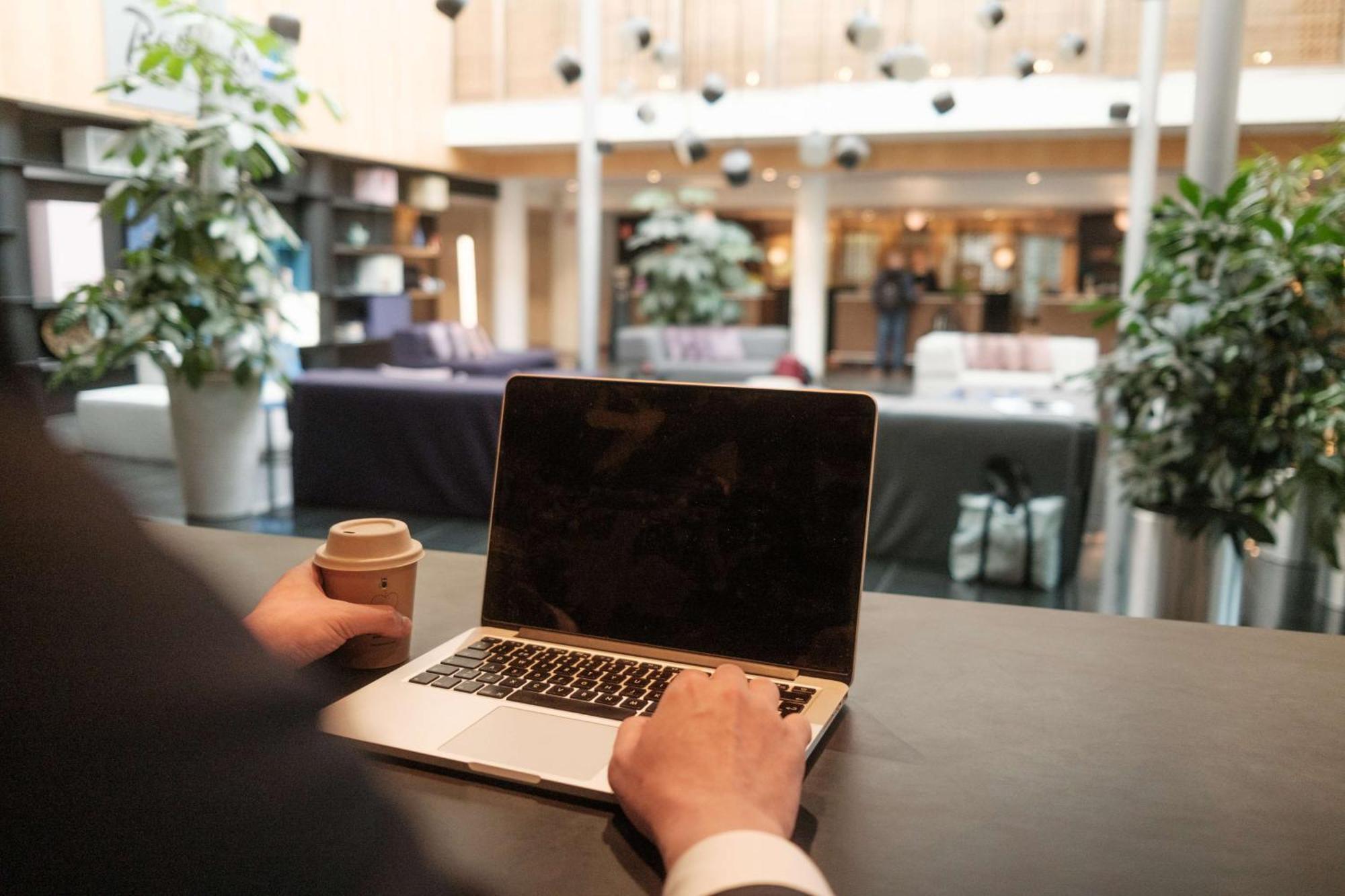 Radisson Blu Airport Terminal Hotel Arlanda Bagian luar foto A man working on a laptop.